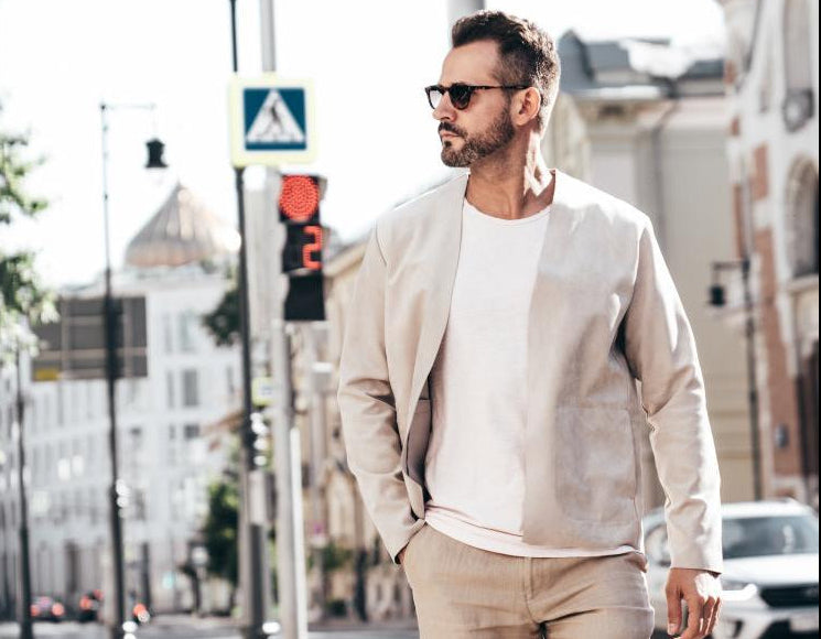 stylish-man-walking-through-a-city-street-on-a-sunny-day-in-a-modern-outfit-with-sunglasses-and-a-confident-demeanor.jpg